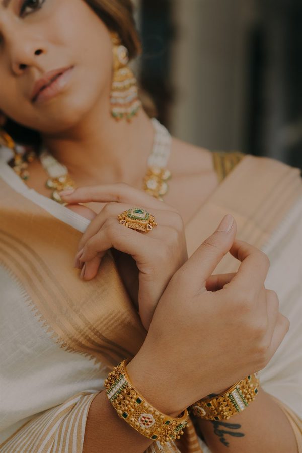Close-up of antique gold bangles and a kundan ring